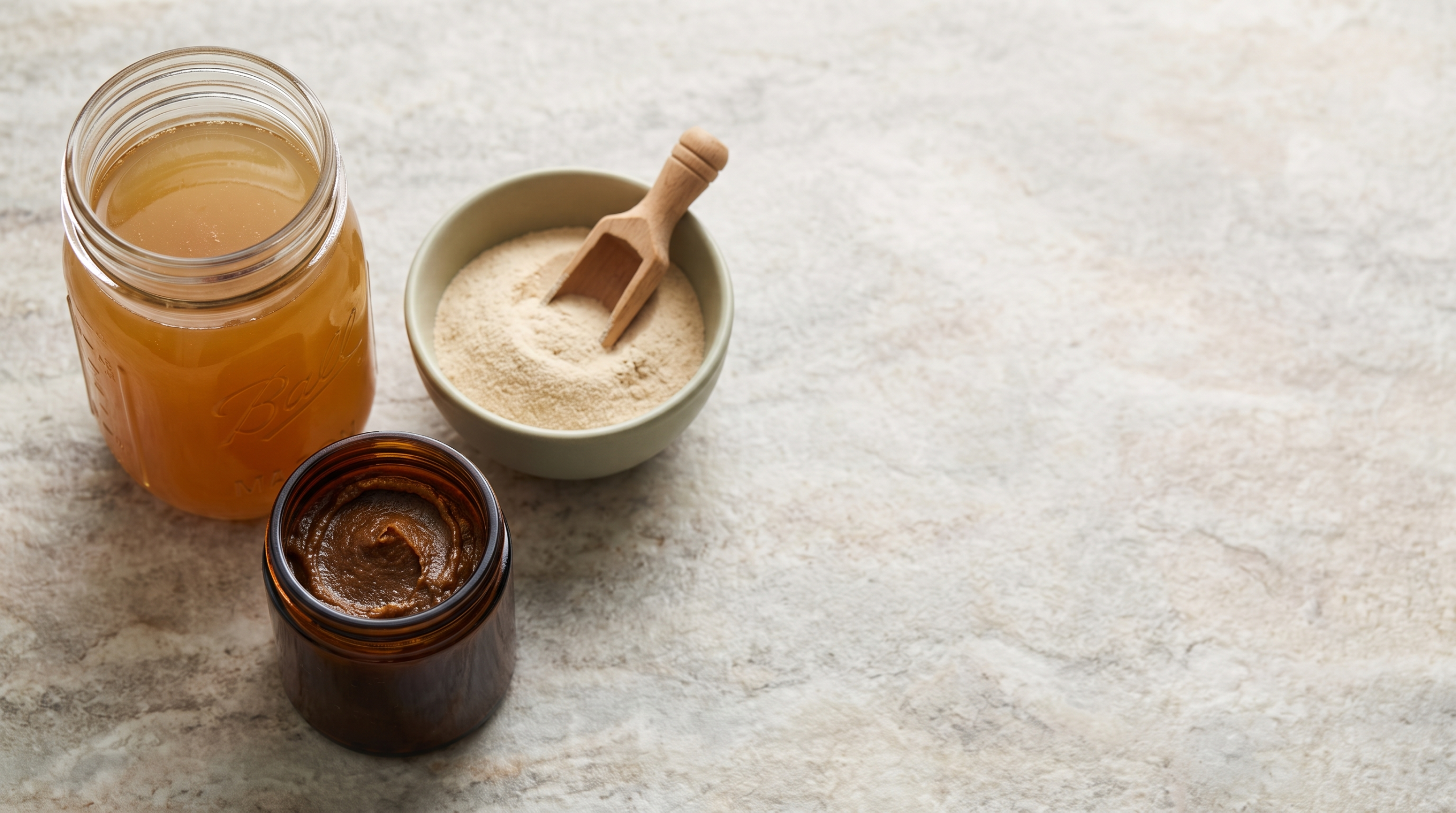 Bone broth shown in liquid, powder, and concentrate forms arranged on a counter